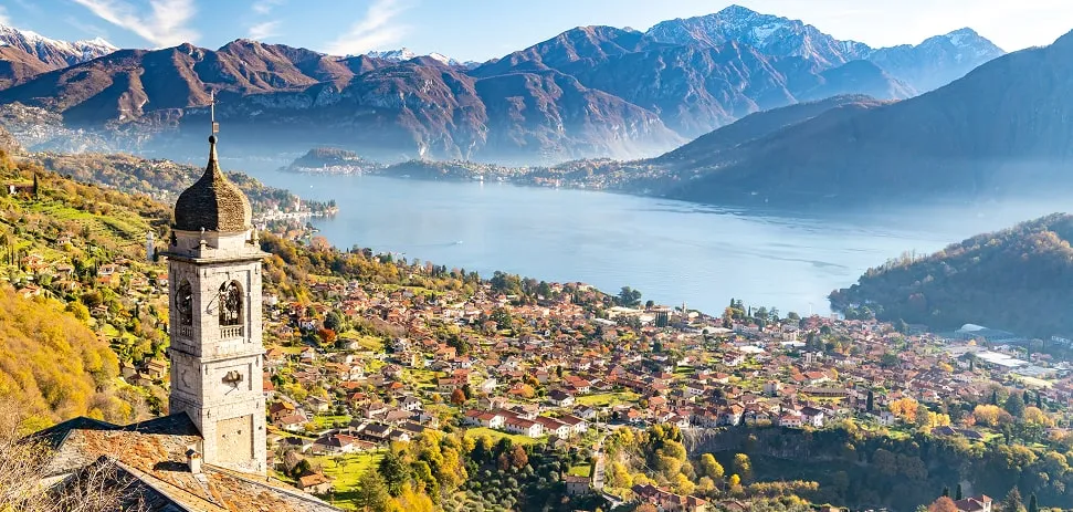 Panoramic view of Lake Como with bell tower and mountains