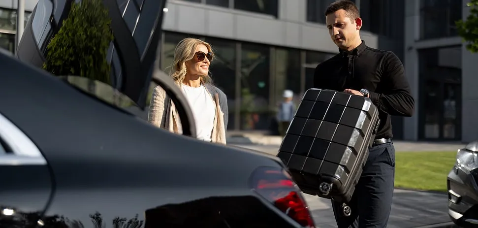 Chauffeur helping guest with luggage during airport transfer to Lake Como