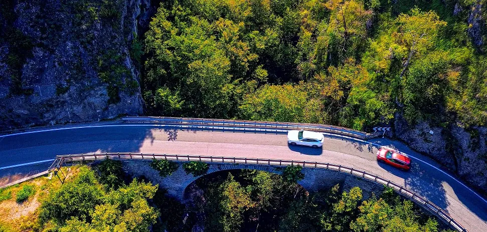 Curvy mountain road near Lake Como with cars driving